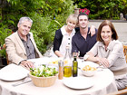 A family eat outdoors